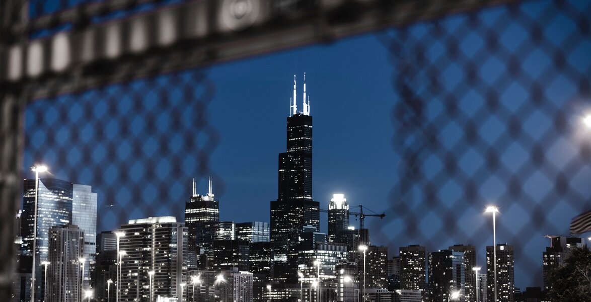 Image of Sears (Willis) Tower through a hole in a fence