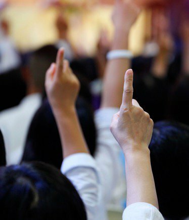 Hands raised to bid on auction sale