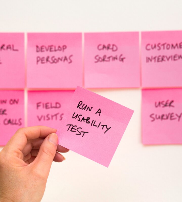 Hand holding a sticky note